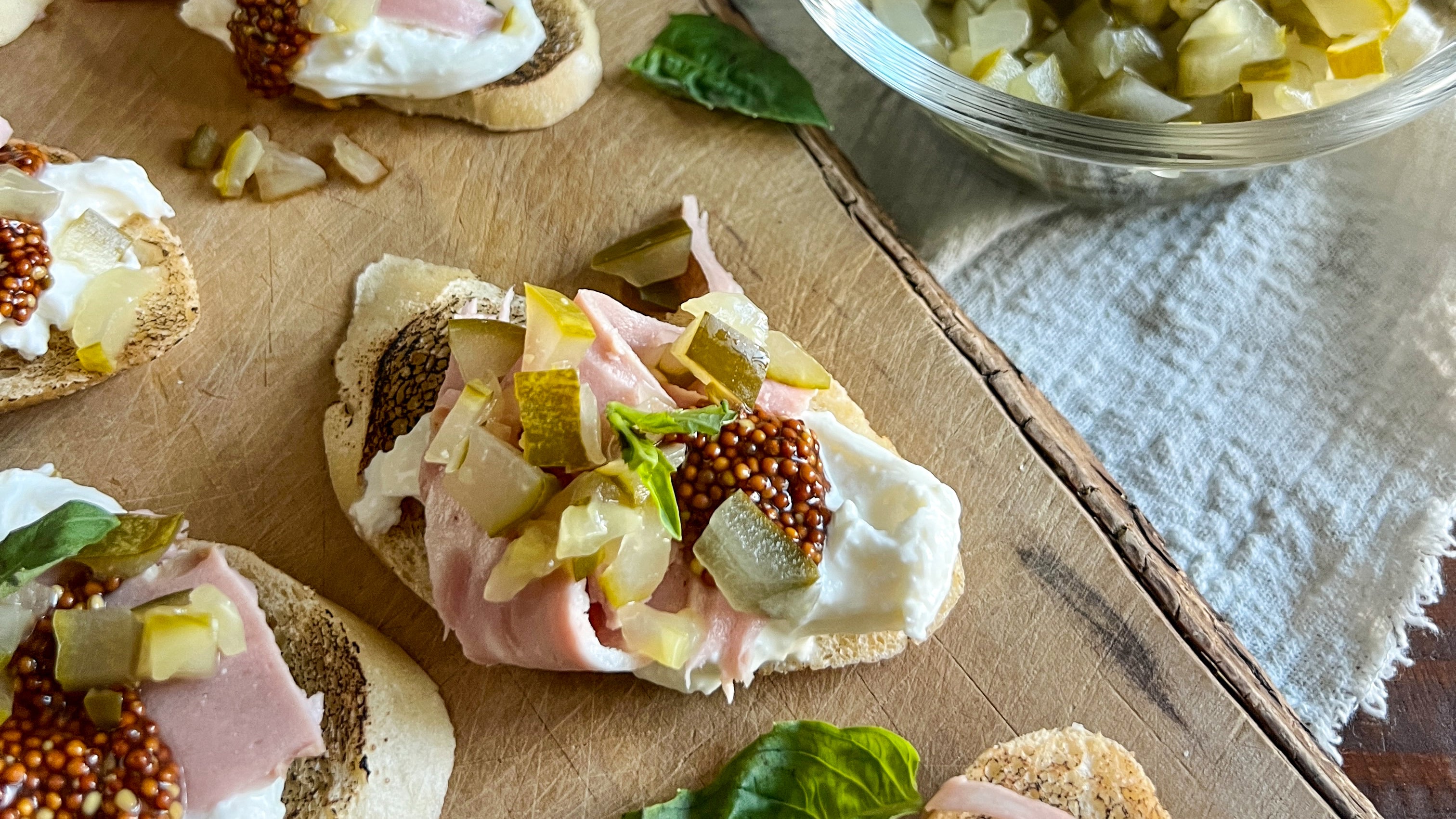 Burrata Crostini with Mortadella and Dill Pickles