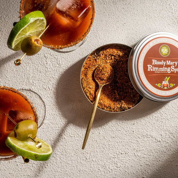 Bloody Mary Rimming Spice tin with Bloody Marys in glasses