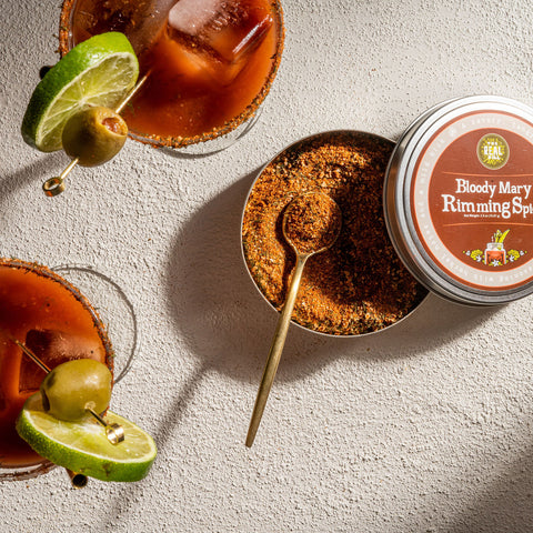 Bloody Mary Rimming Spice tin with Bloody Marys in glasses